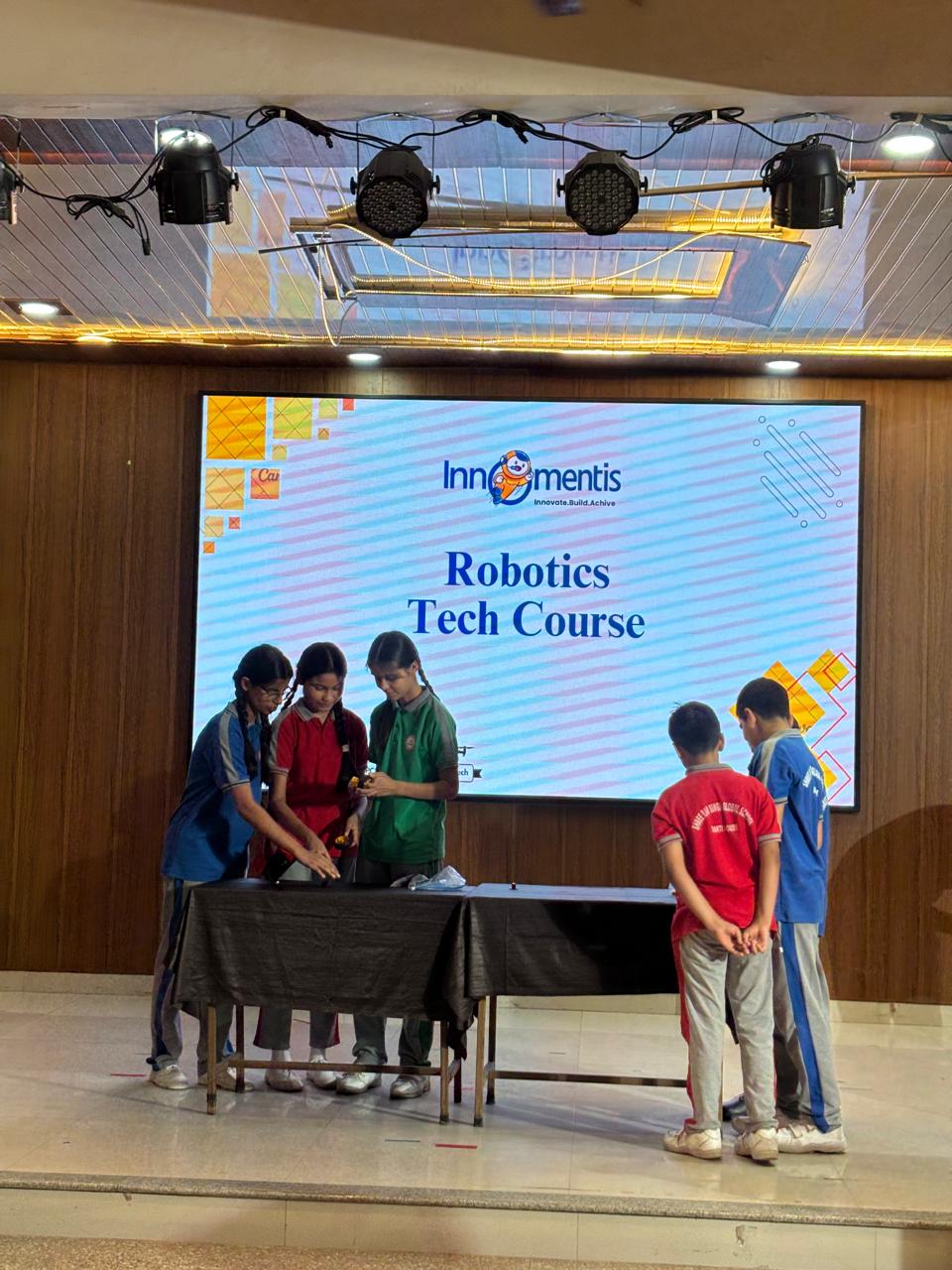 Students Presenting Robotics Project on Stage